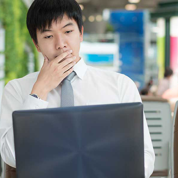a guy looking a laptop